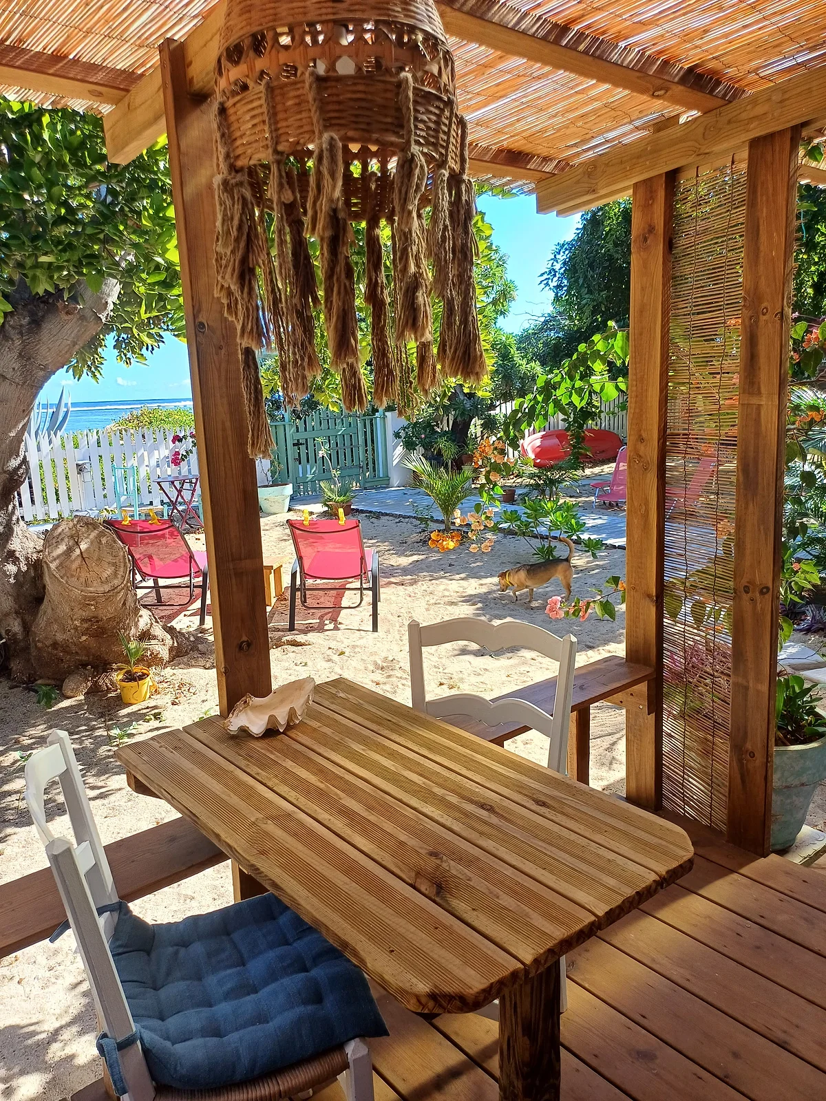 La pergola du jardin, qui ouvre sur la plage et le lagon